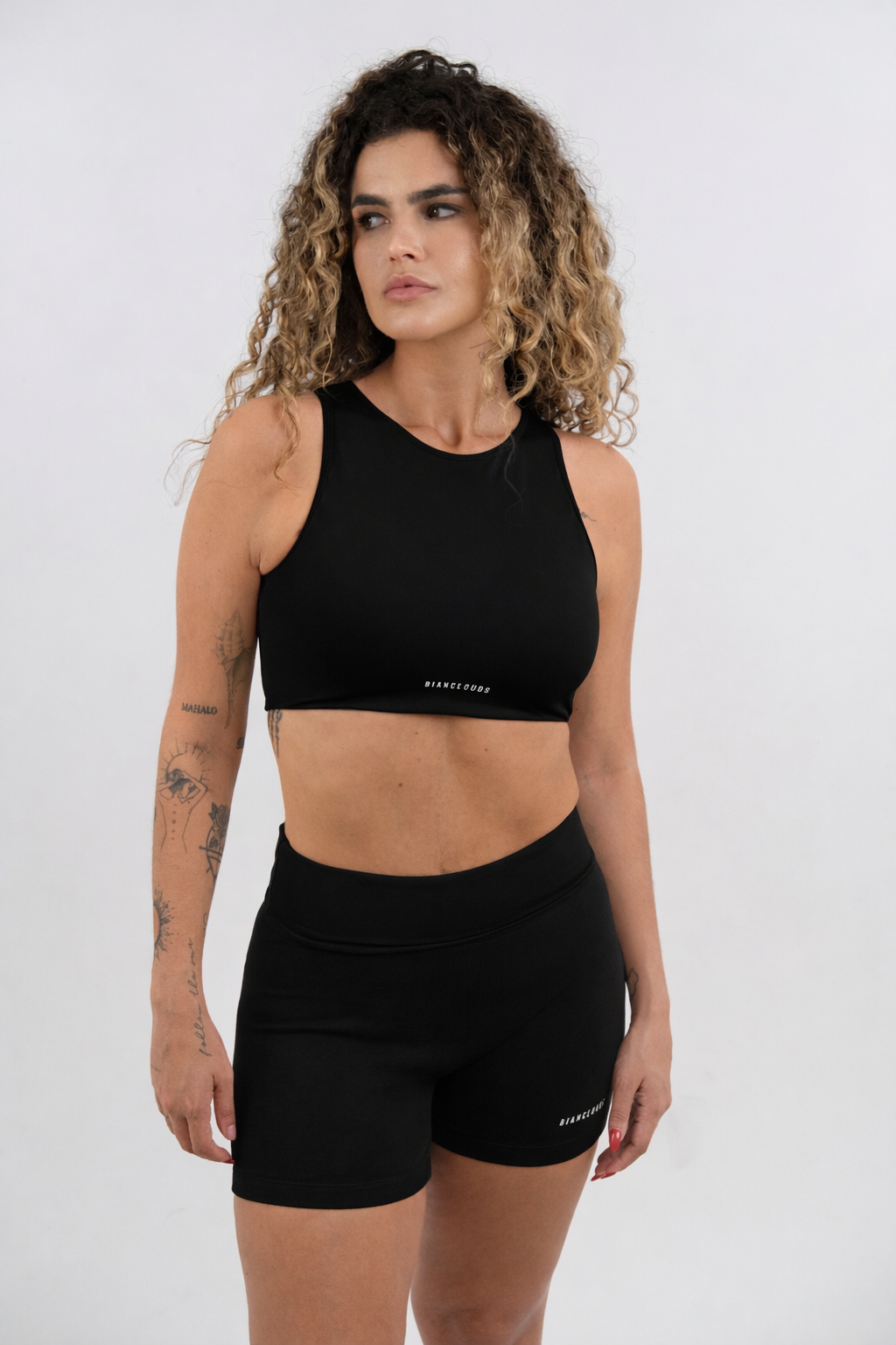Woman wearing a black sports bra and shorts set