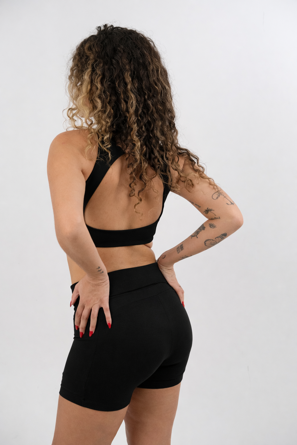 woman wearing a black yoga bra and shorts set