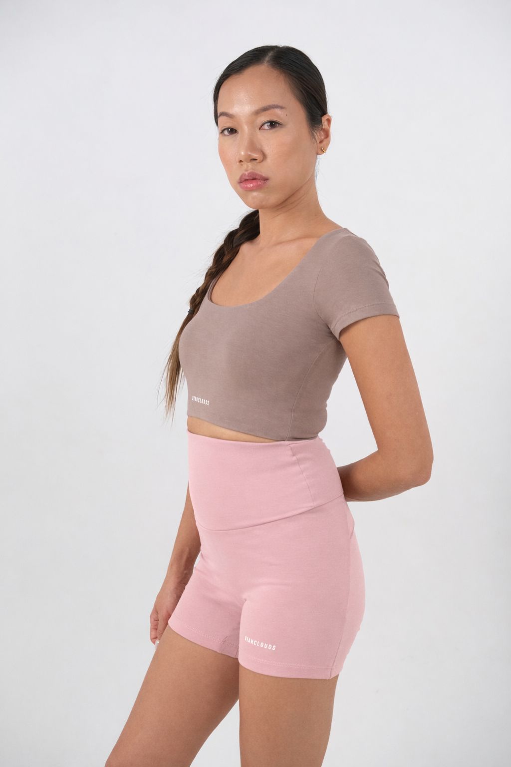 Woman wearing a brown crop top and pink short