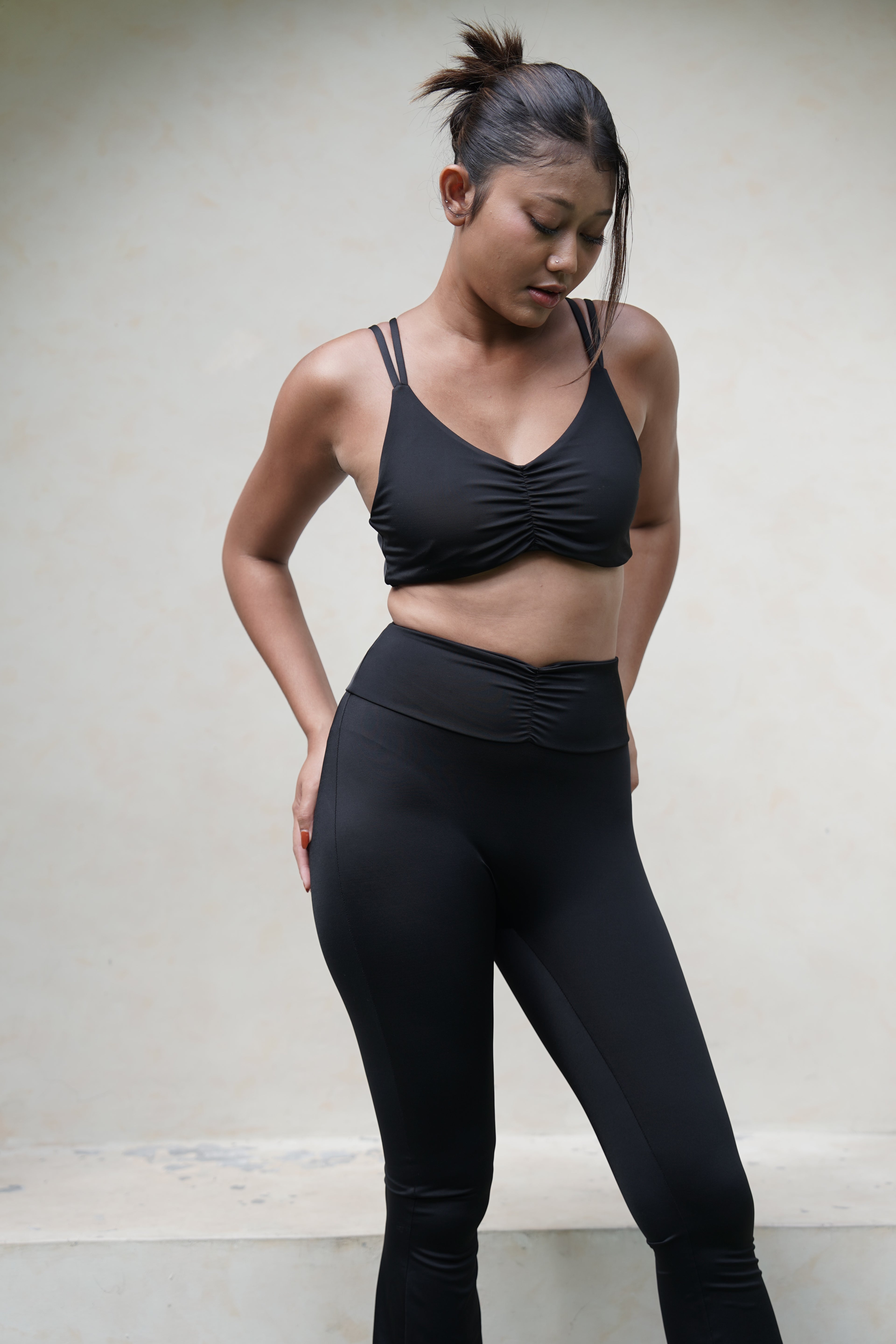Woman in black activewear yoga pants and bra