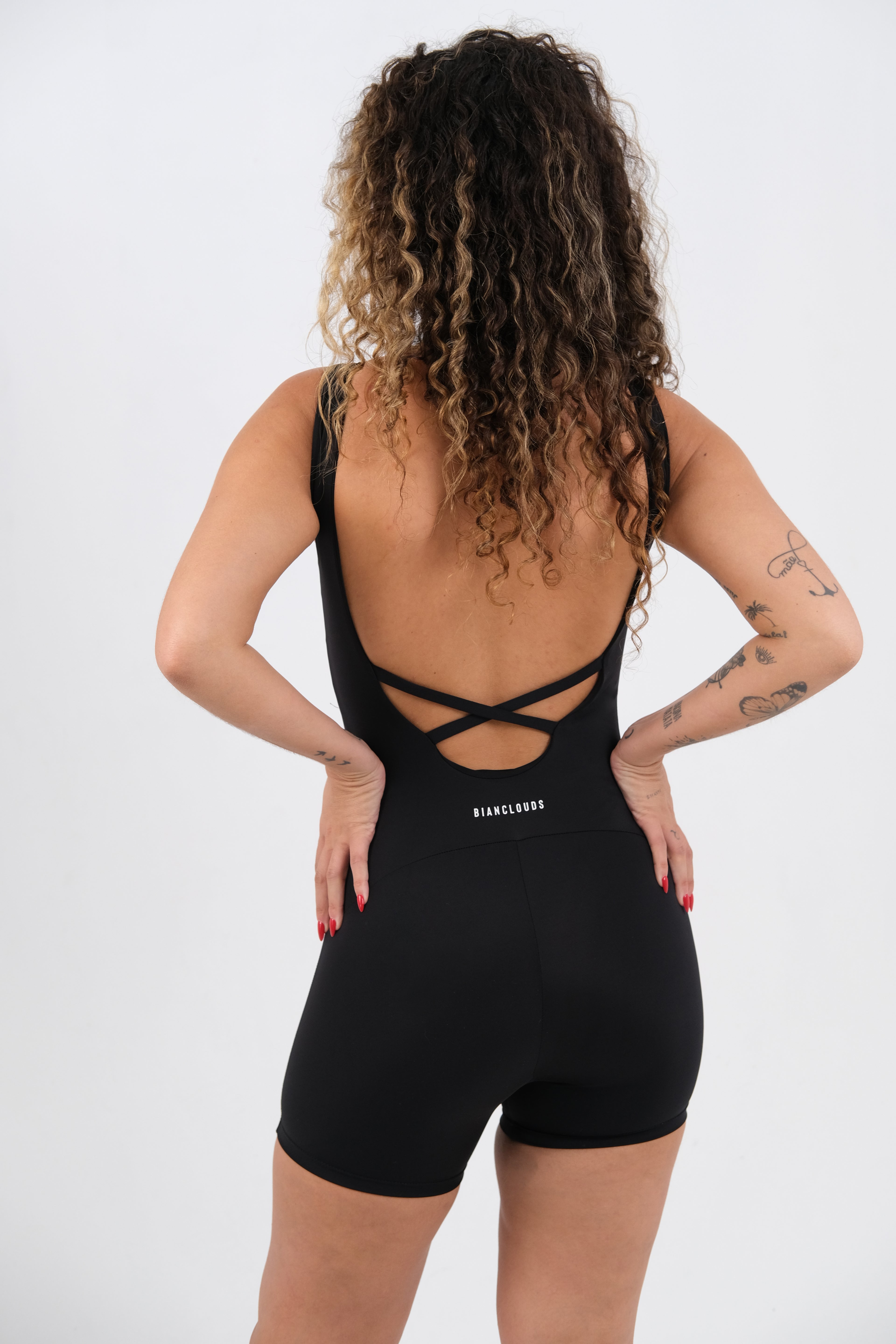brazil girl wearing a black bodysuit with criss-cross straps details at the back