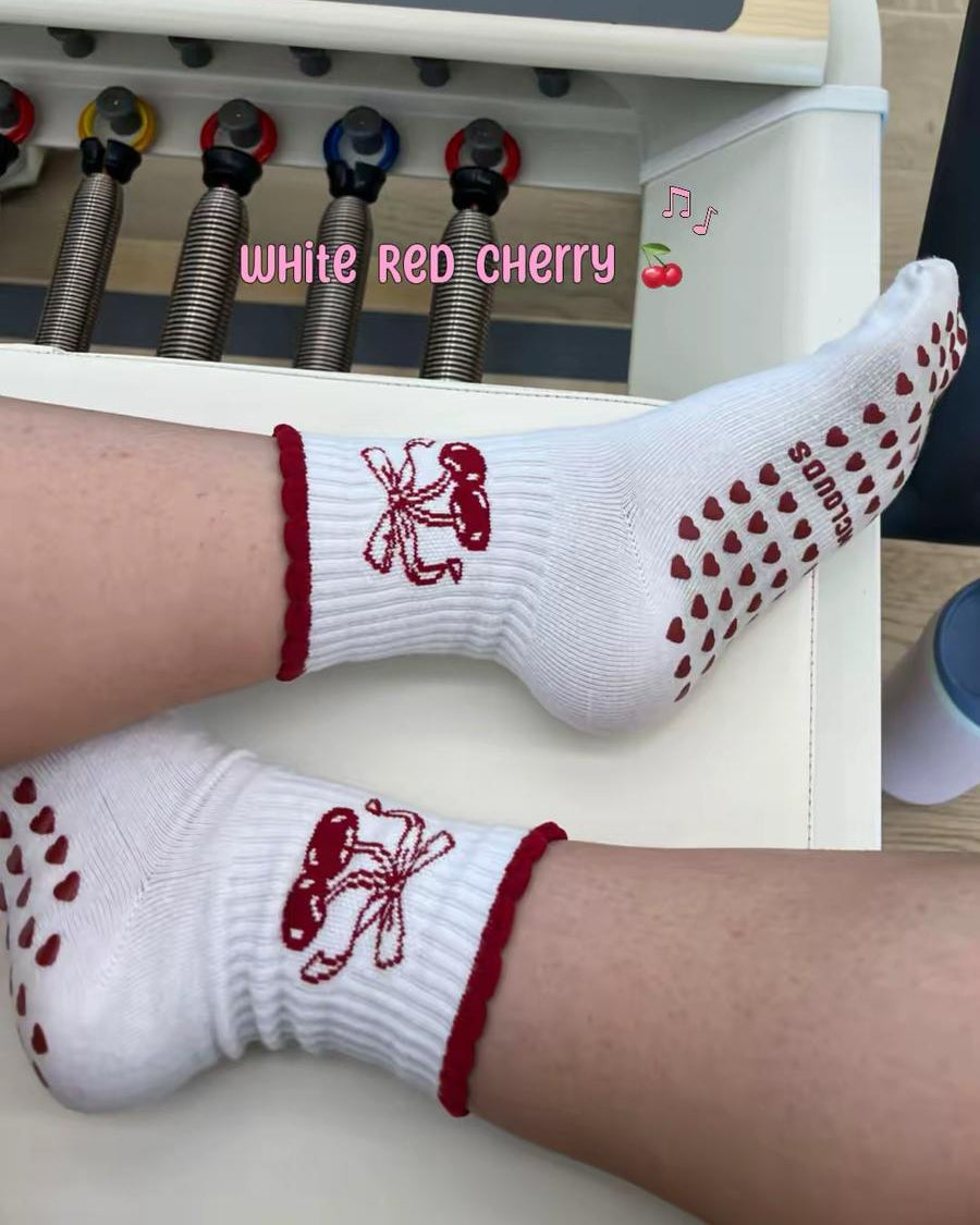 White antislip red cherry socks on pilates reformer