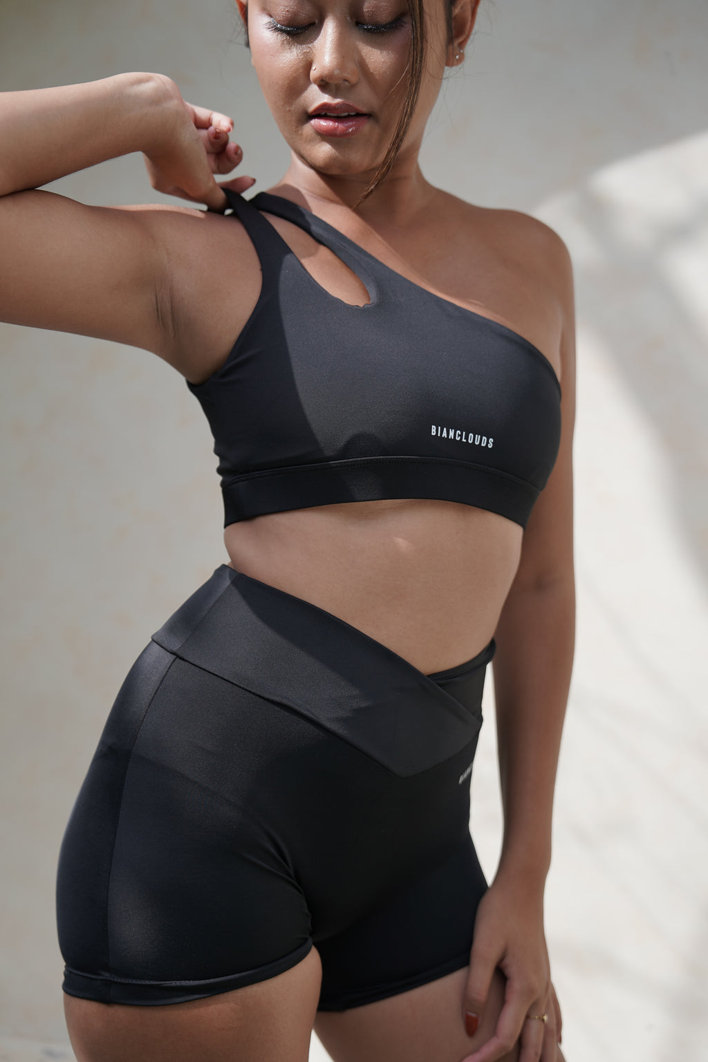 a balinese girl wearing black sport wear shorts and bra top